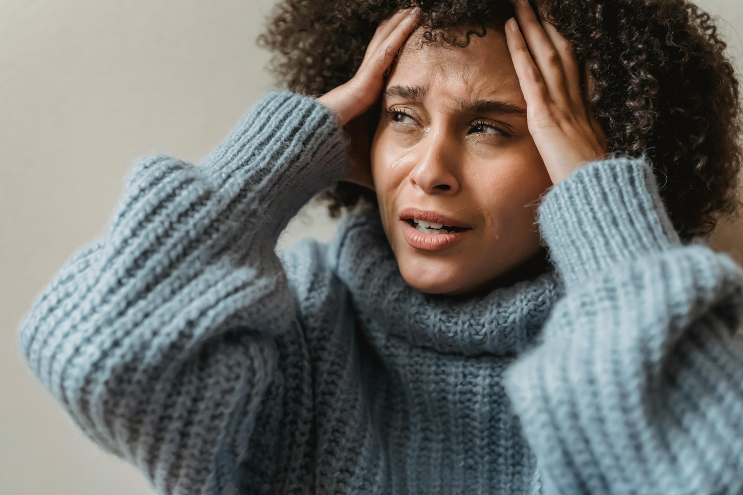 Women holding her head in pain